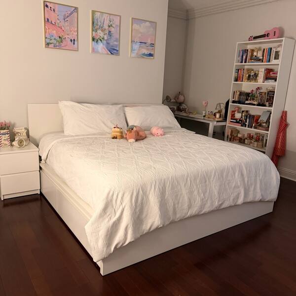 Bright bedroom with hardwood floor cleaned and tidied