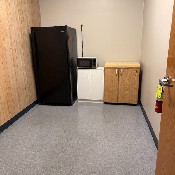 Office breakroom kitchenette tidied with floors mopped