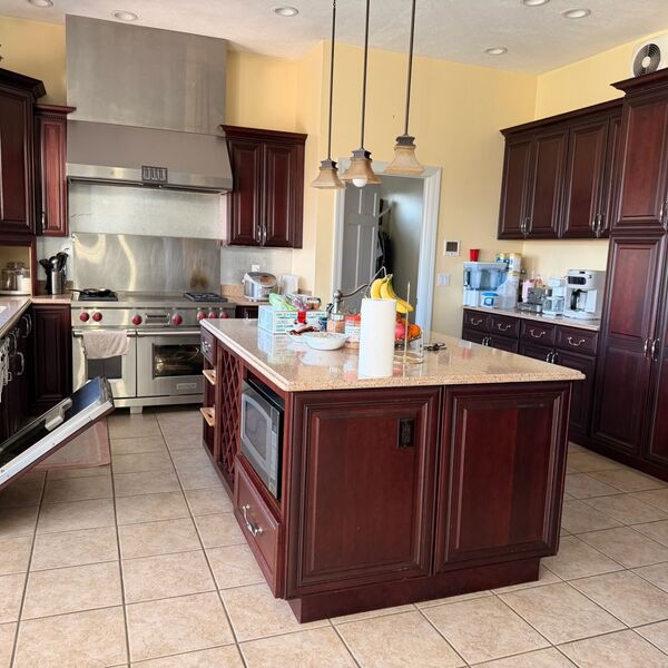 Spacious cherry cabinet kitchen with island deep cleaned