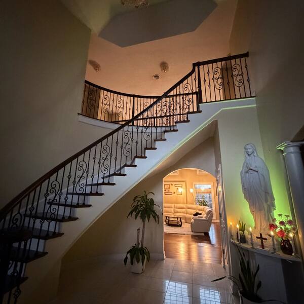 Grand foyer with curved staircase and tile floor cleaned