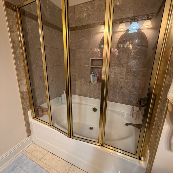 Jacuzzi tub with glass shower doors cleaned spotless