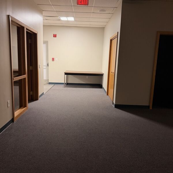 Office corridor with carpet vacuumed and exit clearly marked