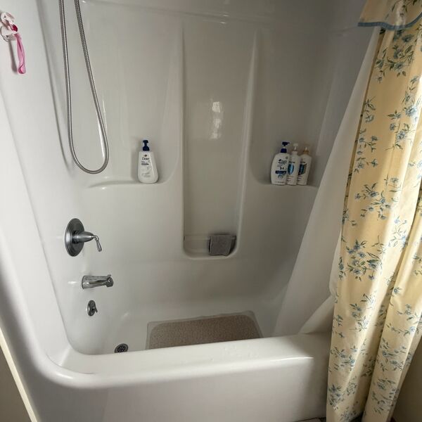 White tub and shower scrubbed and sparkling clean